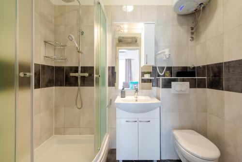 a bathroom with a shower and a sink and a toilet at Studio Apartment & Room TEN - Free parking in Dubrovnik