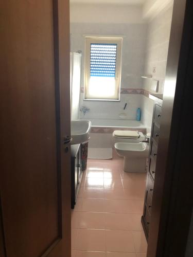 a bathroom with a sink and two sinks and a window at B&B Alberobello Belvedere in Alberobello