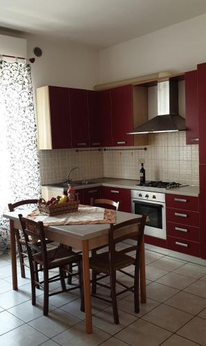 a kitchen with a table with a bowl of fruit on it at Ladybug Apartment in Poggibonsi