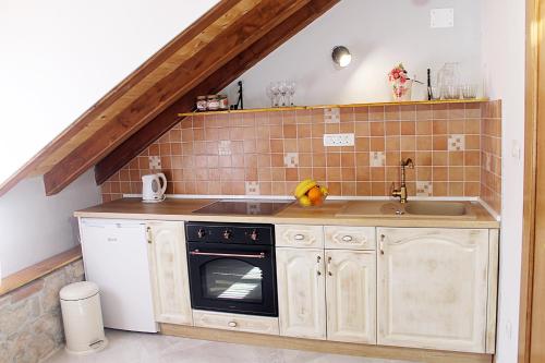a kitchen with a sink and a stove at Apartments D&N in Vis