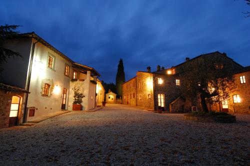 an empty street in a medieval town at night at Relais Borgo Torale in Passignano sul Trasimeno