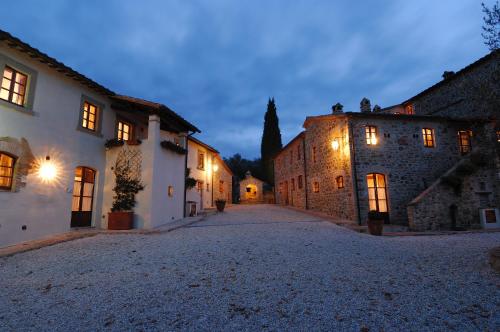 an empty street in a medieval town at night at Relais Borgo Torale in Passignano sul Trasimeno