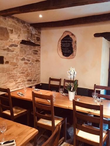a dining room with wooden tables and chairs at Auberge du Lac in Mandailles