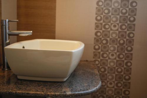 a white sink sitting on a counter in a bathroom at Paradise Perfect in Ooty