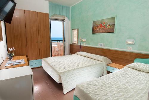 Postel nebo postele na pokoji v ubytování Hotel Napoleon