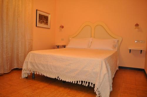a bedroom with a large bed with a white bedspread at L' Aia Antica in Veroli