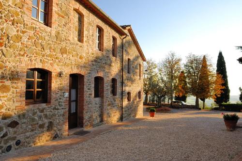 a stone building with a door on the side of it at Relais Borgo Torale in Passignano sul Trasimeno