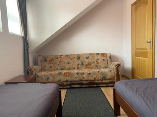 a living room with a couch and a bed at Apartmani Alo Alo (kod Mikija) in Plav