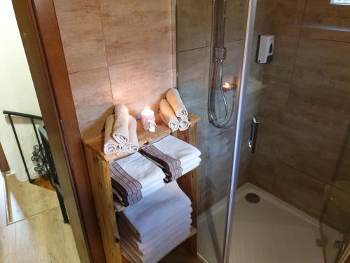 a bathroom with a shower and some towels and a shower at Plitvički San in Korenica