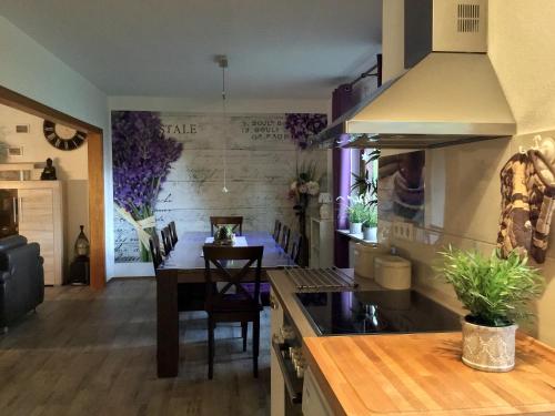a kitchen with a table and a dining room at Haus am See in Schiffdorf