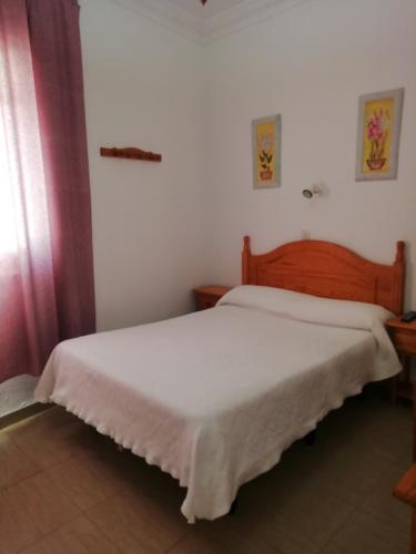 a bedroom with two beds in a room at Hostal Sierpes in Seville