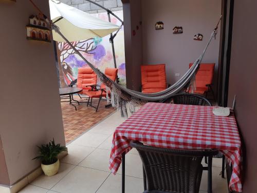 a room with a table and chairs and an umbrella at Casa Sur in Tegucigalpa