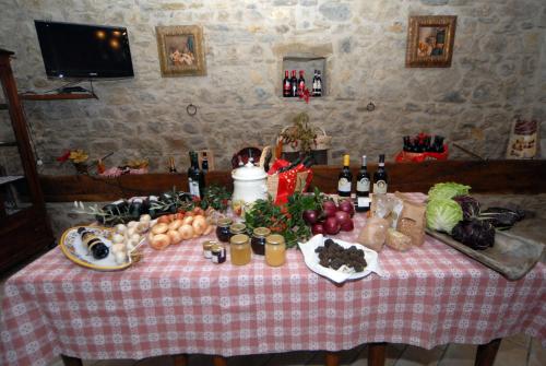 a table with food and bottles of wine on it at Agriturismo Casa Brunori in Foligno