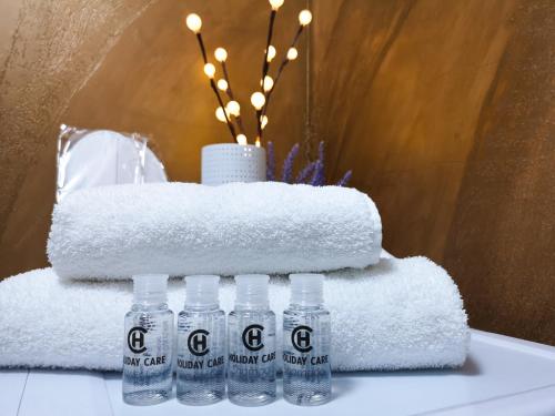 a group of bottles of water on a table with towels at YNS Apartaments in Iaşi