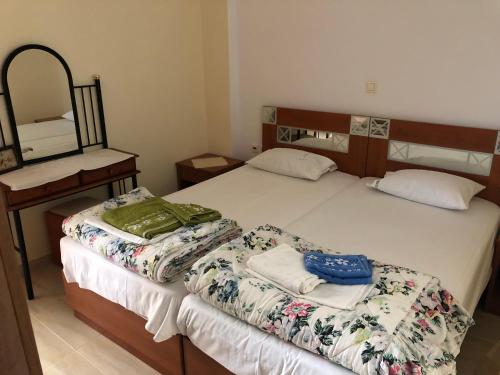 two twin beds in a room with a mirror at Holiday Dream Thalia Apartment in Mastichari