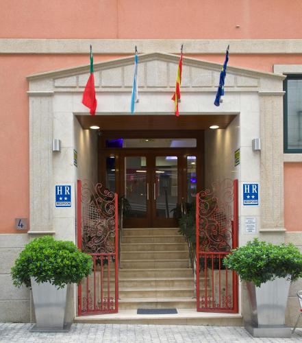 a entrance to a building with flags on it at Hotel Vila da Guarda in A Guarda