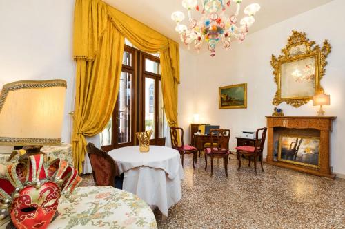 a living room with a table and a fireplace at Luxury Venetian Rooms in Venice