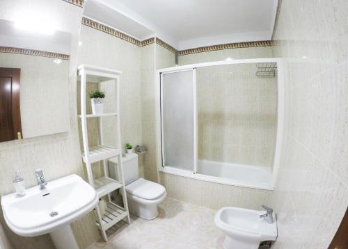 a white bathroom with a sink and a toilet at Apartamento EuroRental con WiFi in Santa Cruz de Tenerife