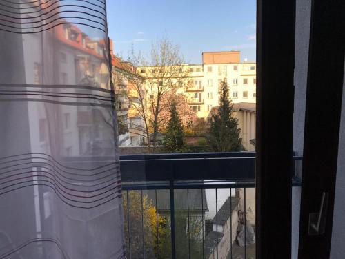 a window with a view of a city with buildings at Central-Apartment-Adria in Saarbrücken
