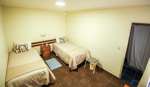 Una cama o camas en una habitación de Hostal del Rio