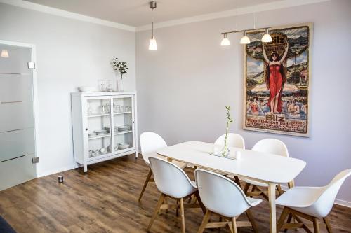 a dining room with a white table and white chairs at DD Apartments in Dresden