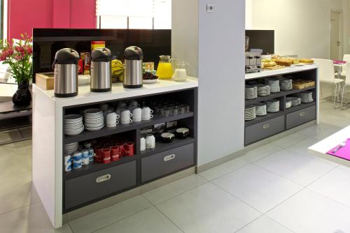 a kitchen with a counter with dishes and condiments at Hotel Vila da Guarda in A Guarda