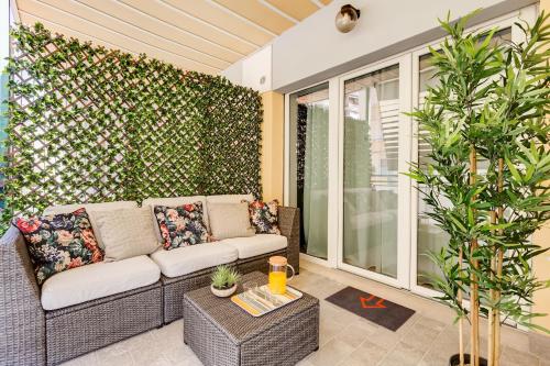 a living room with a couch on a patio at San Pietro Vatican Apartments in Rome