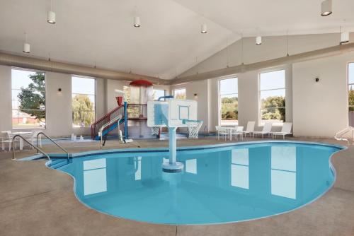 a large pool with a slide in a building at Country Inn & Suites by Radisson, Madison Southwest, WI in Fitchburg