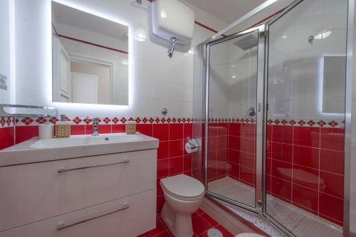 a red bathroom with a toilet and a shower at Casa Giovannina in Conca dei Marini