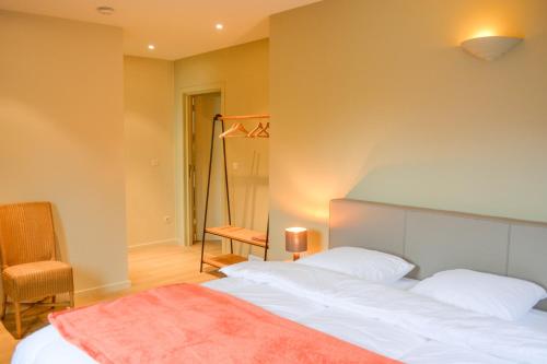 En eller flere senge i et værelse på B&B Onderweg