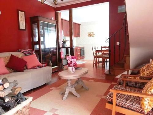 a living room with a couch and a table at Casas do Couratão in Malhadas da Serra
