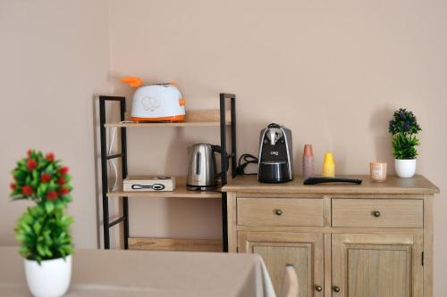 a kitchen with wooden shelves and a coffee maker on a counter at B&B A due passi in Caserta