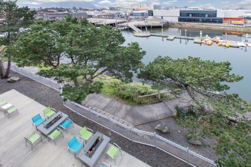 an aerial view of a river with tables and chairs at Holiday Inn Express Hotel & Suites Seaside Convention Center by IHG in Seaside
