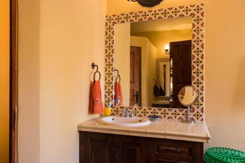 a bathroom with a sink and a mirror at Casa Vista del Mar in Loreto