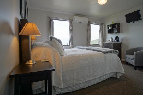 a bedroom with a bed and a table with a lamp at Lands End in Bluff