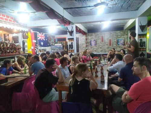 a group of people sitting in a bar playing chess at Las vegas lodge and restaurant in Banaue