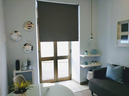 a living room with a couch and a sliding glass door at V4 in Horta