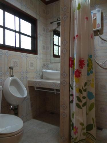 a bathroom with a toilet and a sink at Stella Resort in Sam Roi Yot