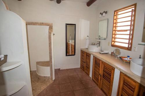 a bathroom with two sinks and a tub and a mirror at CASA TORTUGA, Soliman Bay in Tulum