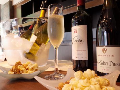 a table with a bottle of wine and a glass at Hotel WBF Sapporo Chuo in Sapporo