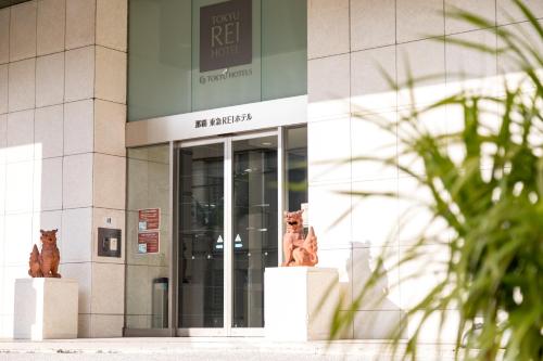 two statues of bears in front of a building at Naha Tokyu REI Hotel in Naha