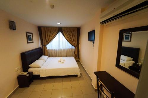 a bedroom with a bed and a large window at Hotel A-One in Kuala Lumpur