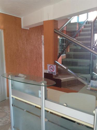 a glass table and a no smoking sign in a building at Hotel Posada Mercy in Río Lagartos