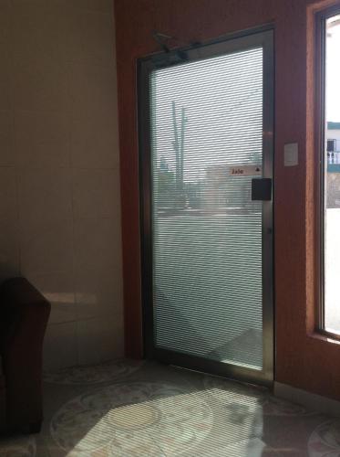 a room with a window with blinds on a door at Hotel Posada Mercy in Río Lagartos