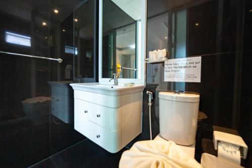 a bathroom with a sink and a toilet at Baanpoon Apartment in Chaweng