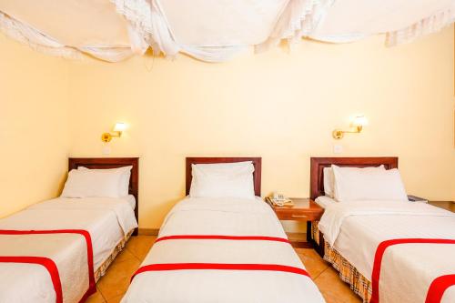 Een bed of bedden in een kamer bij New Safari Hotel