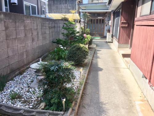 a garden with plants and rocks next to a building at Season 1 in Naoshima