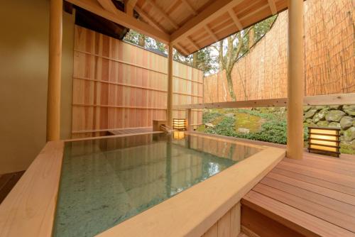 an indoor pool in a house with a wooden deck at Hanaikada in Kyoto