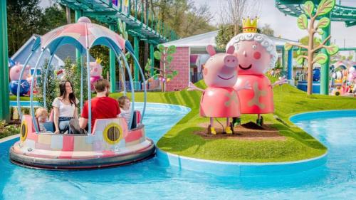 a group of people riding on a train in a water park at Poppy at Oakdene Forest Park in Ringwood