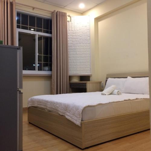 a bedroom with a bed and a window at Maison Royale in Ho Chi Minh City